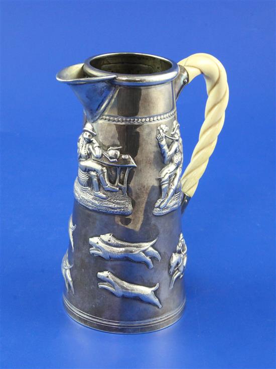 An unusual Victorian silver jug embossed with mortlake scene